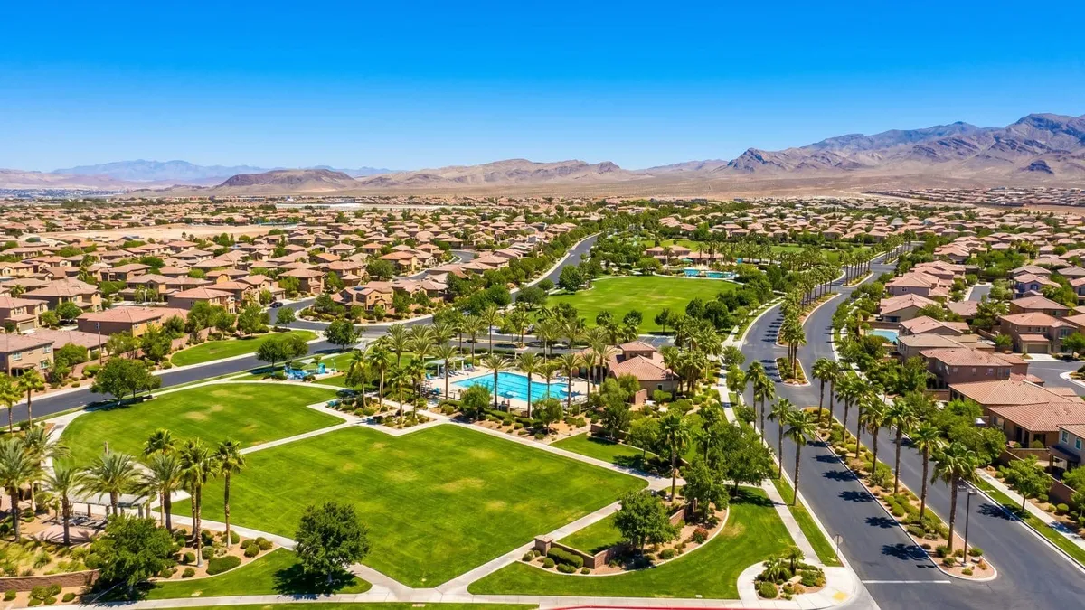 Aerial view of a Henderson master-planned neighborhood with a park and palm-lined streets