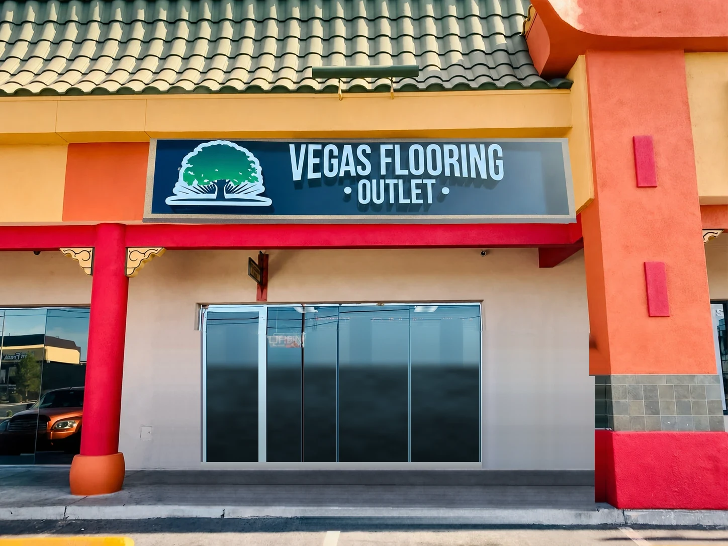 The Vegas Flooring Outlet crew in black team shirts standing in front of the Vegas Flooring Outlet storefront