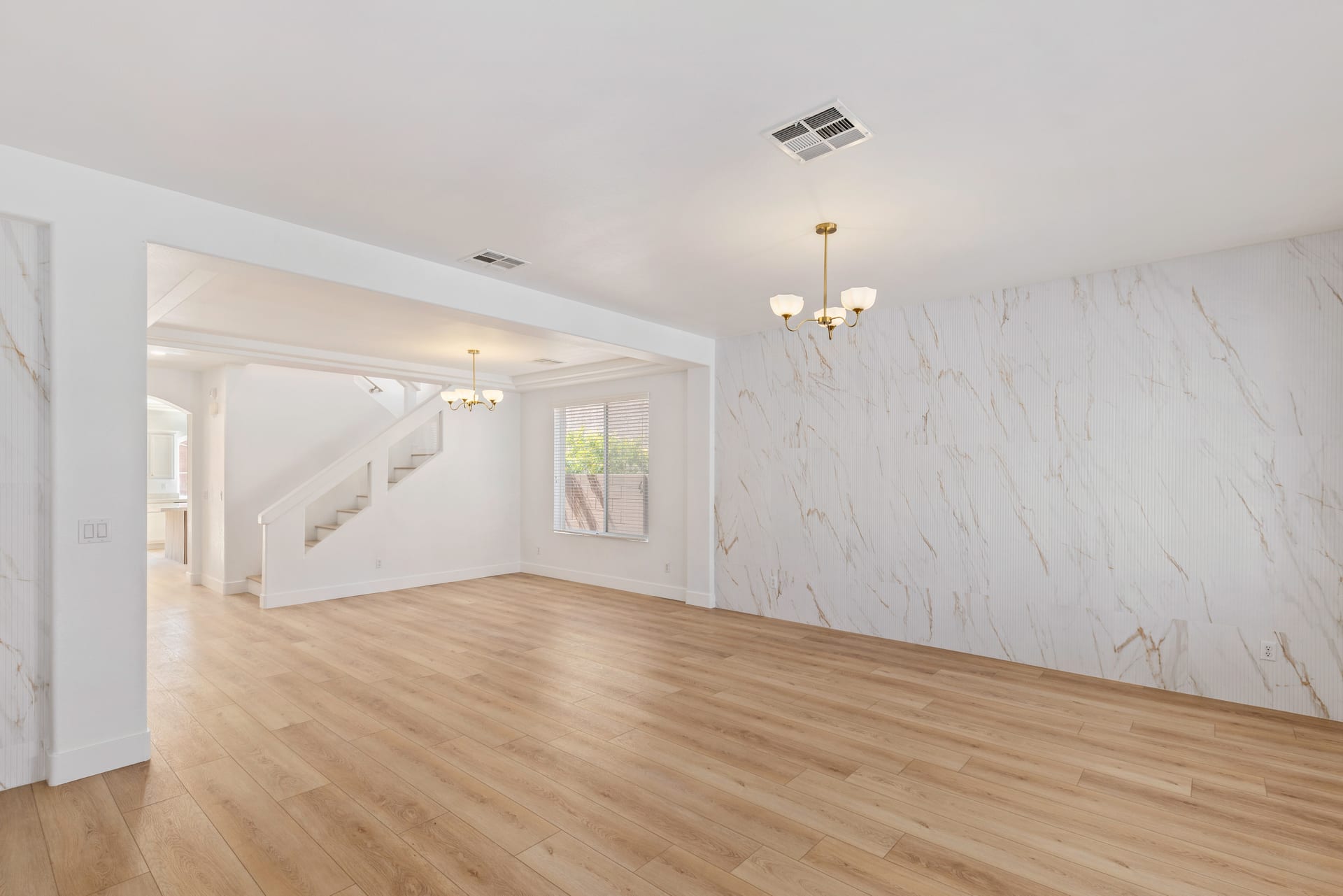 Light wood-look plank flooring flowing toward a staircase in a Las Vegas home